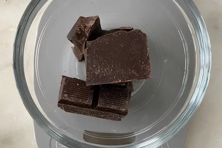 Weigh chocolate in a scale Weigh chocolate in a scale
