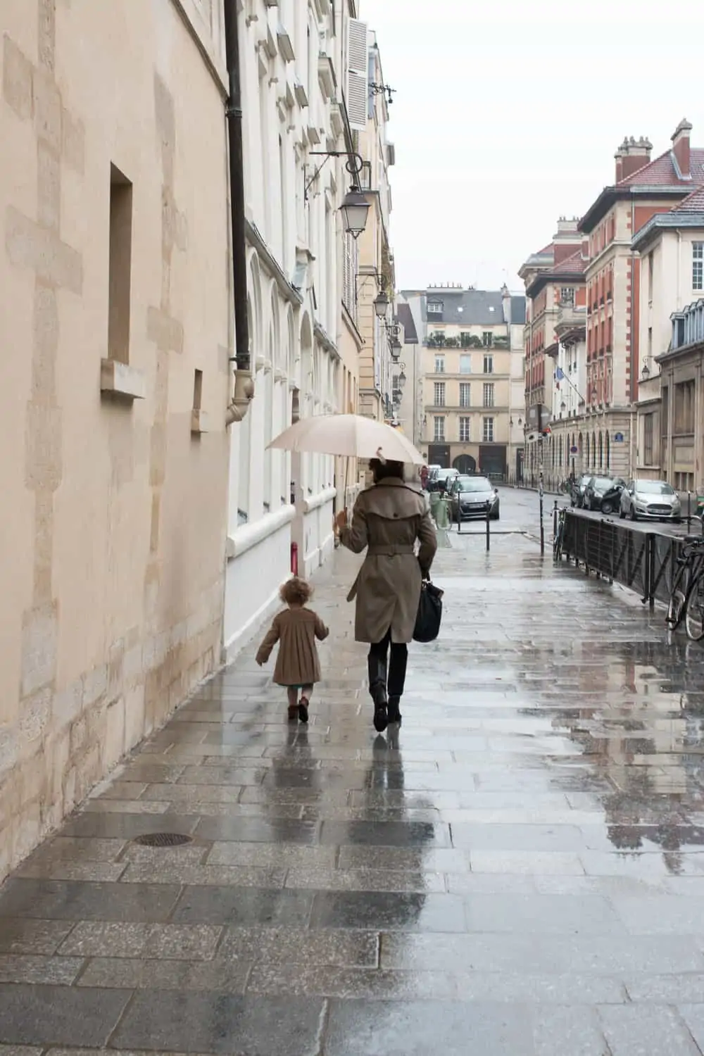 What to Wear in Paris What to Wear in Paris. Mom and baby girl walking in the rain